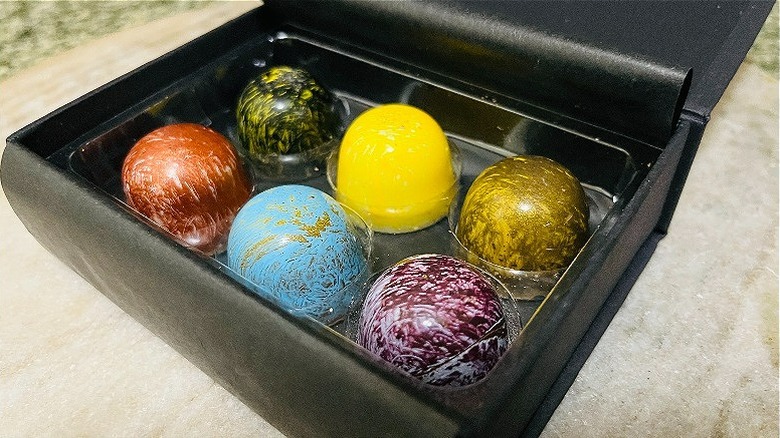 six colorful assorted chocolate truffles