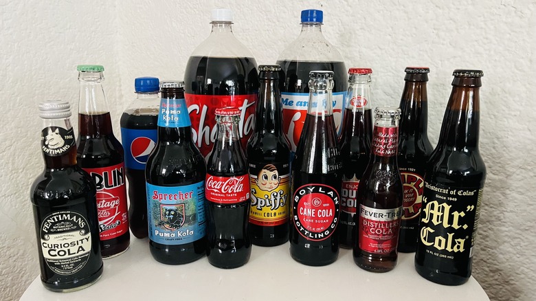 Plastic and glass bottles of cola
