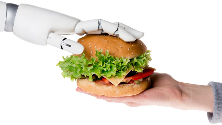 robot handing human fast food burger