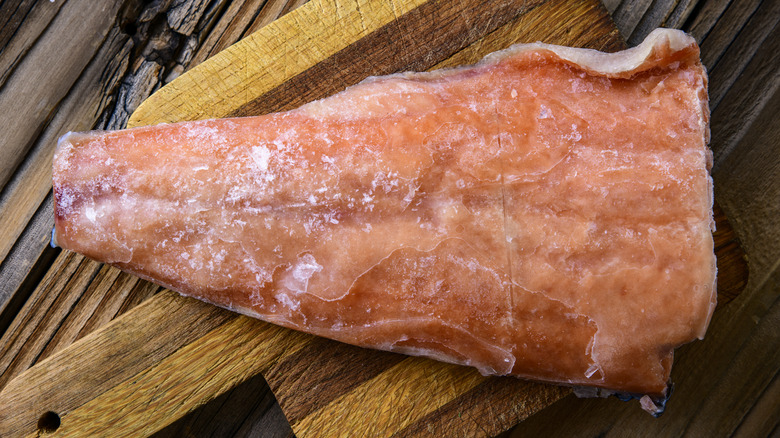 frozen salmon on wooden board