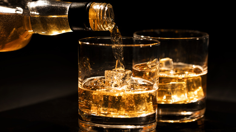 bourbon pouring into glasses
