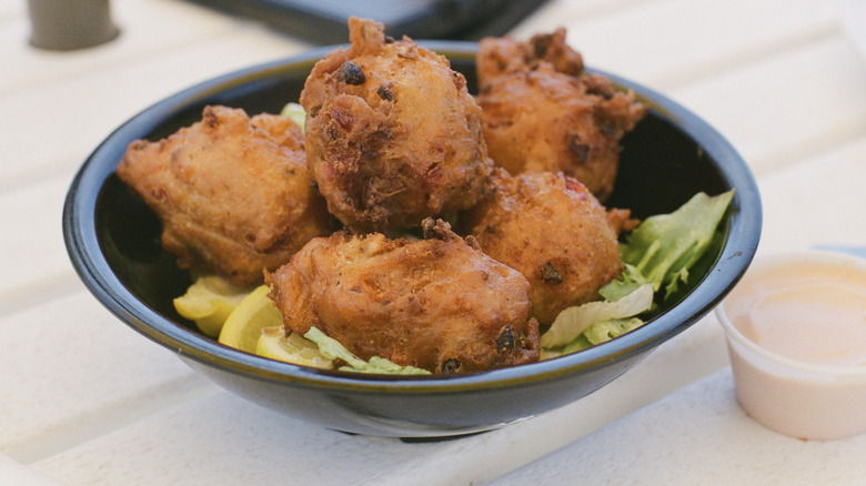 Conch fritters in black bowl