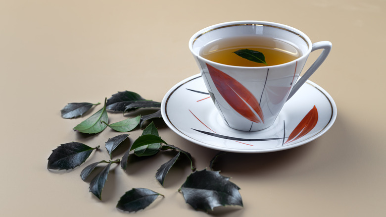 Yaupon tea in teacup and leaves